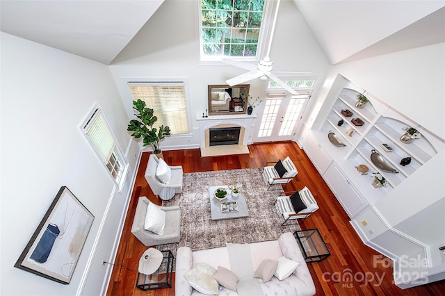 7554 Bluestar Ln, Charlotte, NC 28226 - living room featuring high vaulted ceiling, a ceiling fan, a fireplace with flush hearth, and wood finished floors