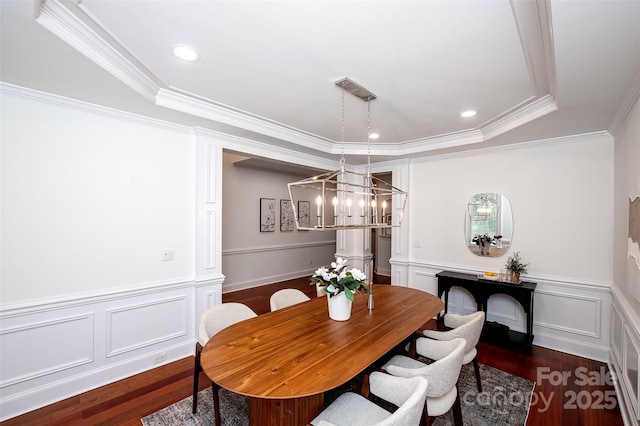 7554 Bluestar Ln, Charlotte, NC 28226 - dining area featuring wood finished floors, crown molding, a wainscoted wall, a decorative wall, and a chandelier