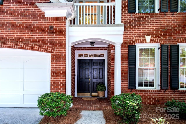 7554 Bluestar Ln, Charlotte, NC 28226 - entrance to property featuring brick siding, a garage, and a balcony