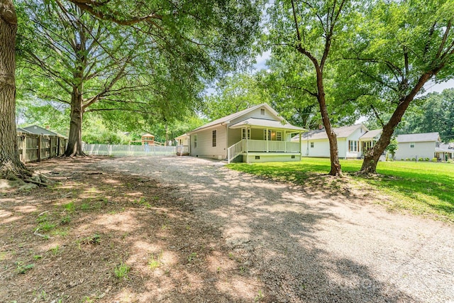 909 Lakeview St, Kannapolis, NC 28083 - view of front facade with a porch, driveway, and view of wooded area