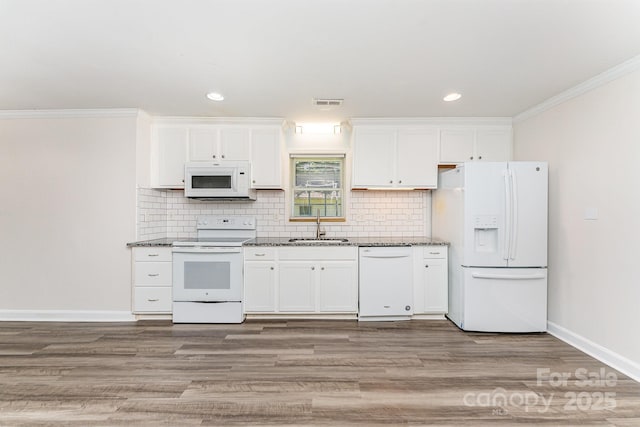 909 Lakeview St, Kannapolis, NC 28083 - kitchen with white appliances, white cabinets, tasteful backsplash, light wood-type flooring, and crown molding