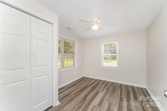 909 Lakeview St, Kannapolis, NC 28083 - unfurnished bedroom featuring wood finished floors, a closet, and ceiling fan