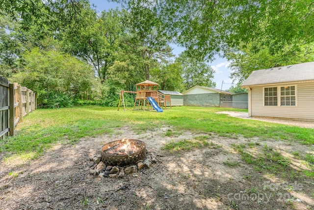909 Lakeview St, Kannapolis, NC 28083 - fenced backyard with a fire pit and a playground