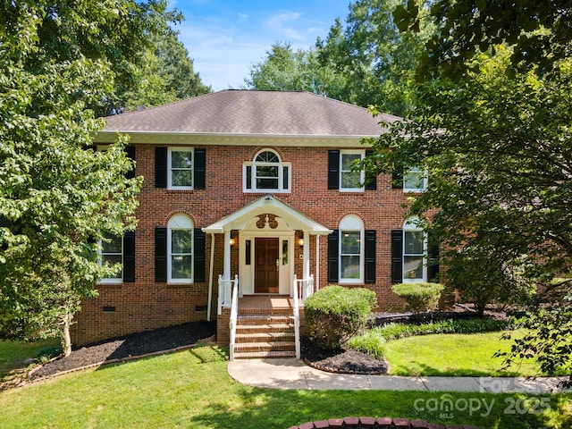 1134 Willow Oaks Trl, Matthews, NC 28104 - georgian-style home with a front yard, roof with shingles, and brick siding