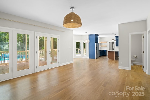1134 Willow Oaks Trl, Matthews, NC 28104 - unfurnished living room featuring french doors and light wood-style flooring