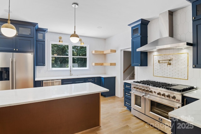 1134 Willow Oaks Trl, Matthews, NC 28104 - kitchen featuring wall chimney exhaust hood, blue cabinetry, stainless steel appliances, and decorative backsplash