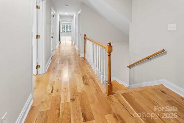 1134 Willow Oaks Trl, Matthews, NC 28104 - hall featuring light wood-type flooring and an upstairs landing