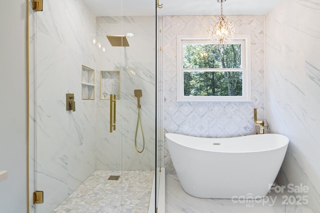 1134 Willow Oaks Trl, Matthews, NC 28104 - full bath featuring a freestanding bath, a marble finish shower, a chandelier, and tile walls