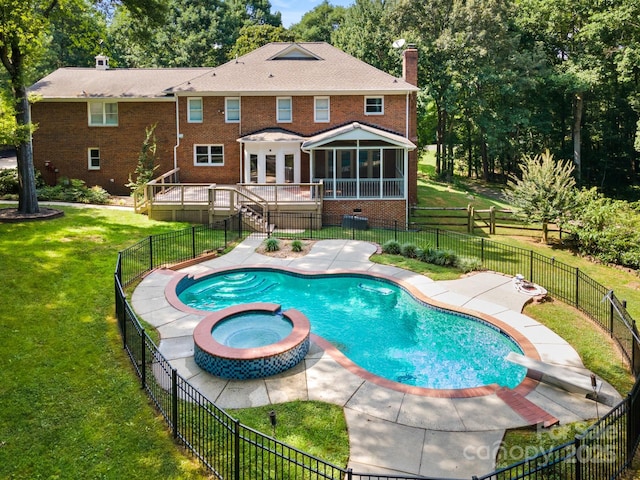 1134 Willow Oaks Trl, Matthews, NC 28104 - view of pool featuring a sunroom, a patio area, a pool with connected hot tub, a deck, and a fenced backyard