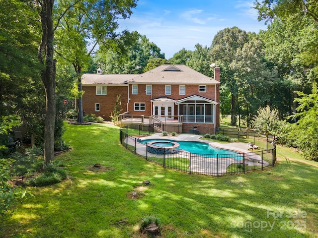 1134 Willow Oaks Trl, Matthews, NC 28104 - back of property featuring an in-ground hot tub, a sunroom, a chimney, brick siding, and a patio