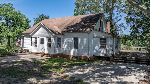 5560 Springs Rd, Conover, NC 28613 - view of front of home with a deck, roof with shingles, a chimney, and a patio