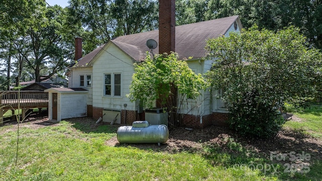 5560 Springs Rd, Conover, NC 28613 - rear view of house with a chimney, a deck, a shingled roof, and a yard
