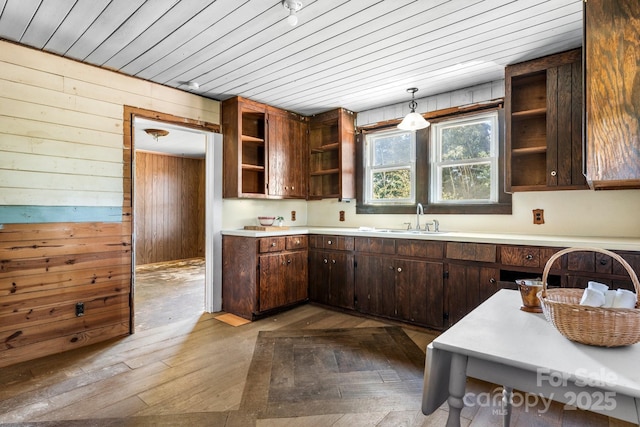 5560 Springs Rd, Conover, NC 28613 - kitchen featuring open shelves, wood walls, light countertops, hardwood / wood-style flooring, and dark brown cabinets
