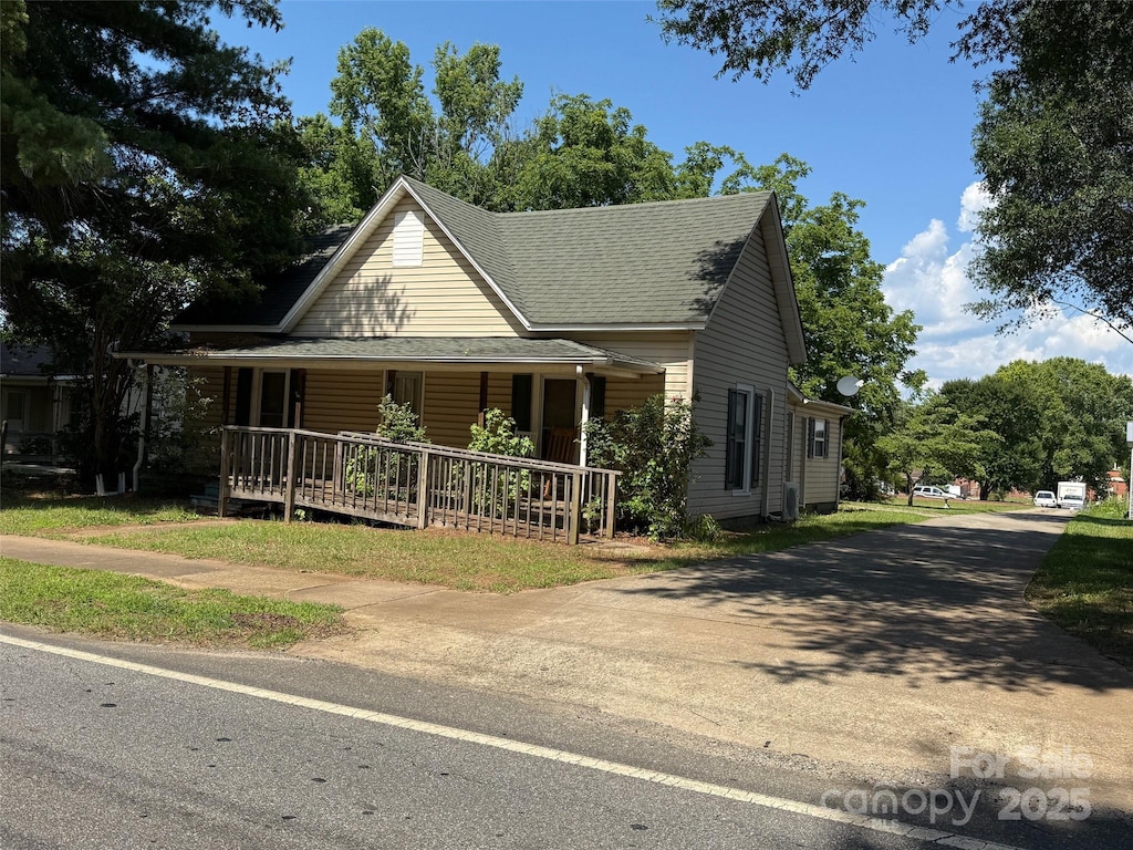 2944 N Lookout St, Claremont, NC 28610 - farmhouse-style home featuring a porch and a shingled roof
