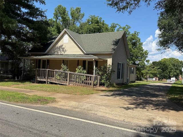 2944 N Lookout St, Claremont, NC 28610 - farmhouse-style home featuring a porch and a shingled roof