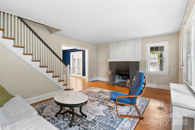 30 Caledonia Rd, Asheville, NC 28803 - living room featuring stairway, light wood-style flooring, and a brick fireplace