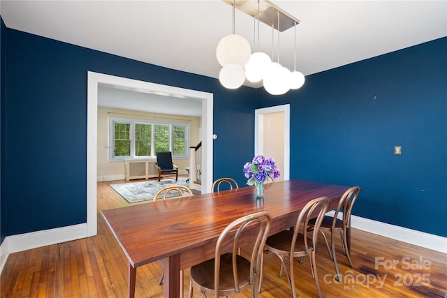 30 Caledonia Rd, Asheville, NC 28803 - dining space featuring a chandelier, wood-type flooring, and radiator heating unit