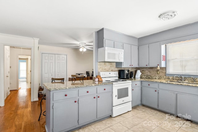 662 Willa Ct Unit 8, Chester, SC 29706 - kitchen with white appliances, a peninsula, backsplash, ceiling fan, and healthy amount of natural light