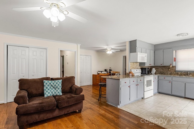 662 Willa Ct Unit 8, Chester, SC 29706 - kitchen with white appliances, a ceiling fan, a peninsula, open floor plan, and gray cabinetry