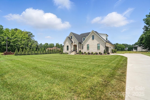 19 Berea Baptist Church Rd, Stanfield, NC 28163 - french country inspired facade with concrete driveway, an attached garage, a front lawn, and brick siding