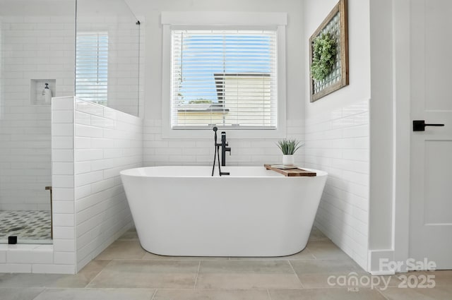 19 Berea Baptist Church Rd, Stanfield, NC 28163 - bathroom with tile walls, a stall shower, a soaking tub, and tile patterned floors