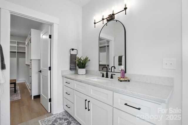 19 Berea Baptist Church Rd, Stanfield, NC 28163 - bathroom featuring vanity, a walk in closet, and wood finished floors