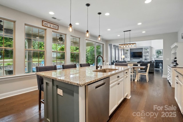 5105 Paisano Ln, Waxhaw, NC 28173 - kitchen featuring dishwasher, white cabinets, dark wood finished floors, light stone counters, and recessed lighting