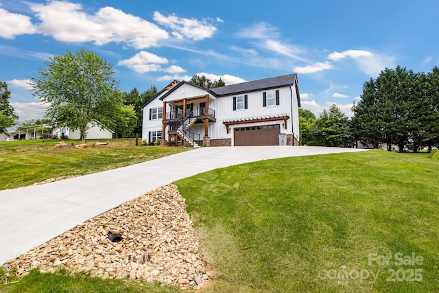 2205 Olde W Rd, Hudson, NC 28638 - view of front of house featuring board and batten siding, a garage, stairs, and a front yard