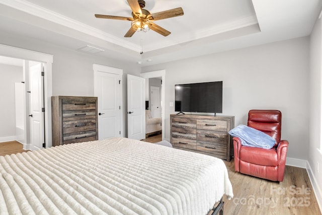 2205 Olde W Rd, Hudson, NC 28638 - bedroom with light wood finished floors, a raised ceiling, crown molding, ensuite bath, and a ceiling fan