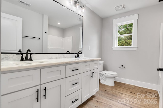2205 Olde W Rd, Hudson, NC 28638 - bathroom featuring double vanity, a shower, and wood finished floors