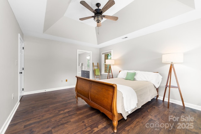 5408 Apple Glen Dr, Harrisburg, NC 28075 - bedroom with a tray ceiling, wood finished floors, a ceiling fan, and connected bathroom
