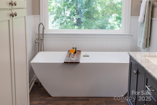 5408 Apple Glen Dr, Harrisburg, NC 28075 - full bathroom with a soaking tub, a wainscoted wall, vanity, plenty of natural light, and wood finished floors