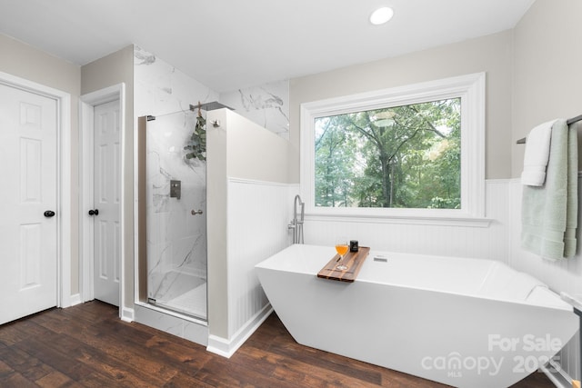 5408 Apple Glen Dr, Harrisburg, NC 28075 - full bath featuring a freestanding bath, a marble finish shower, wainscoting, and wood finished floors