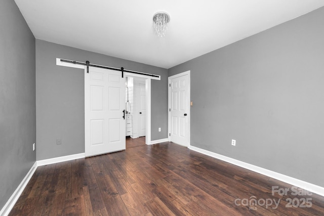 5408 Apple Glen Dr, Harrisburg, NC 28075 - unfurnished bedroom with a barn door and wood finished floors