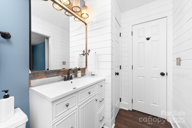 5408 Apple Glen Dr, Harrisburg, NC 28075 - bathroom with a chandelier, wood walls, vanity, and wood finished floors