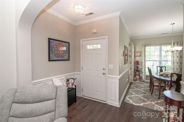1304 Hammond Dr, Matthews, NC 28104 - foyer featuring dark wood-style flooring, plenty of natural light, crown molding, a chandelier, and arched walkways