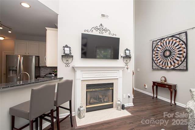 1304 Hammond Dr, Matthews, NC 28104 - living area with dark wood-style floors, a premium fireplace, and recessed lighting