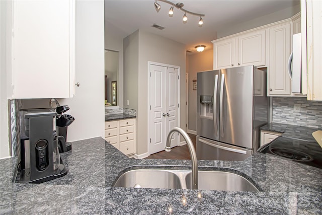 1304 Hammond Dr, Matthews, NC 28104 - kitchen with stainless steel fridge with ice dispenser, white cabinets, tasteful backsplash, and dark stone countertops