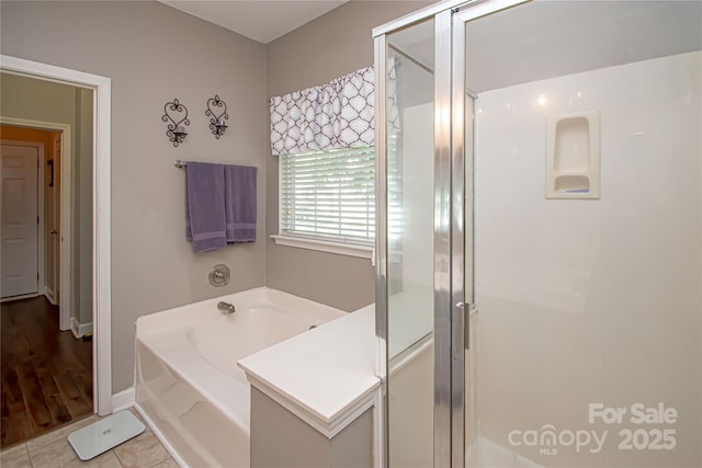 1304 Hammond Dr, Matthews, NC 28104 - bathroom with a bath, a shower stall, and tile patterned floors