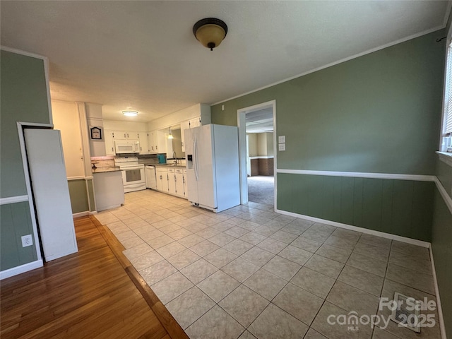 5367 Meadowlane Dr, Granite Falls, NC 28630 - kitchen featuring white appliances, crown molding, a wainscoted wall, and light tile patterned floors