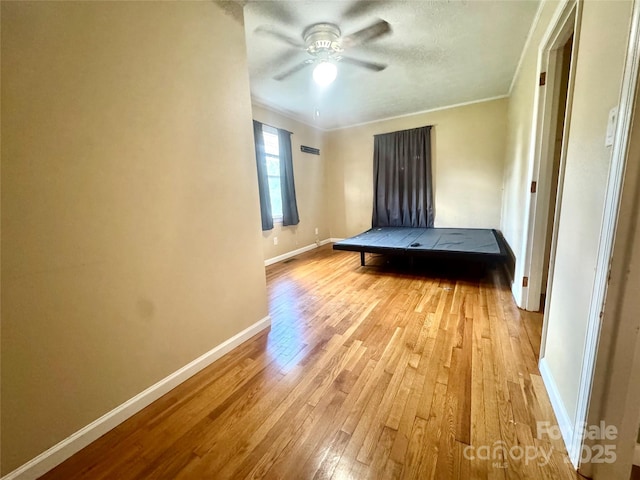 5367 Meadowlane Dr, Granite Falls, NC 28630 - unfurnished bedroom featuring light wood finished floors, ornamental molding, and ceiling fan