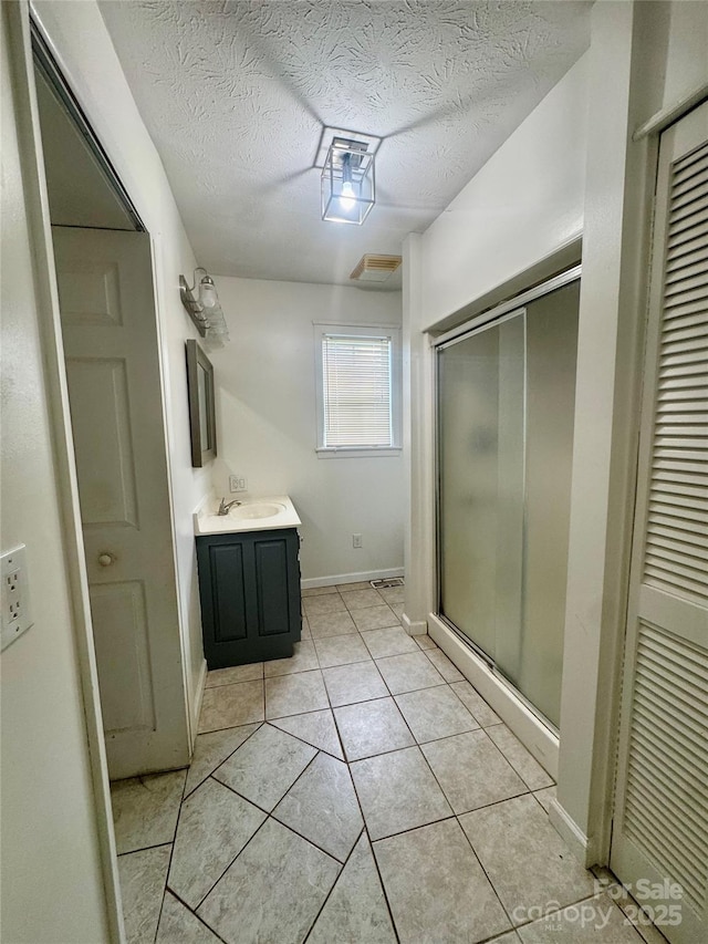 5367 Meadowlane Dr, Granite Falls, NC 28630 - bathroom with vanity, a shower stall, a textured ceiling, and tile patterned floors