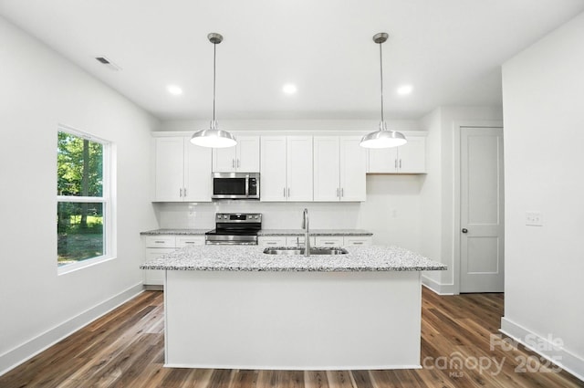 411 Patience Dr, Concord, NC 28025 - kitchen featuring appliances with stainless steel finishes, white cabinetry, an island with sink, tasteful backsplash, and recessed lighting