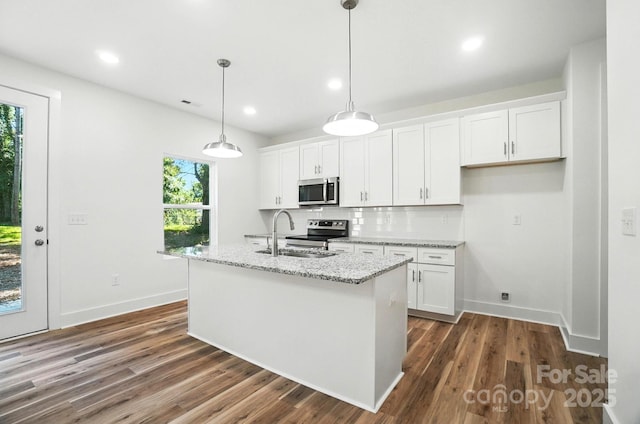411 Patience Dr, Concord, NC 28025 - kitchen featuring stainless steel appliances, white cabinetry, dark wood-style flooring, recessed lighting, and a kitchen island with sink