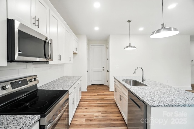 411 Patience Dr, Concord, NC 28025 - kitchen with appliances with stainless steel finishes, light wood-type flooring, white cabinets, and recessed lighting