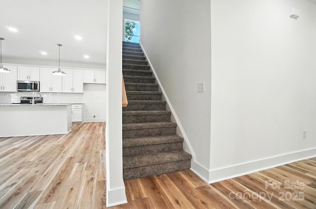 411 Patience Dr, Concord, NC 28025 - staircase featuring wood finished floors and recessed lighting