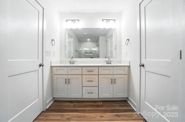 411 Patience Dr, Concord, NC 28025 - bathroom with double vanity, an enclosed shower, and wood finished floors