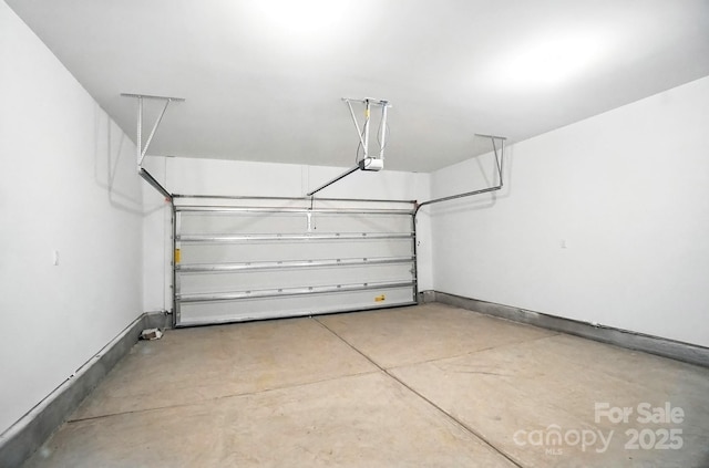 411 Patience Dr, Concord, NC 28025 - garage with a garage door opener and baseboards