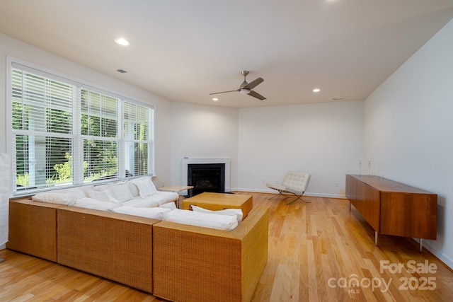 2407 Baxter Pl SE, Concord, NC 28025 - living area featuring light wood-type flooring, a fireplace, a ceiling fan, and recessed lighting