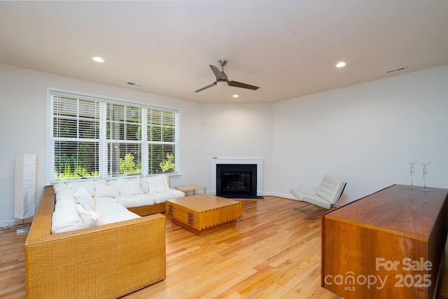 2407 Baxter Pl SE, Concord, NC 28025 - living area with light wood-style flooring, ceiling fan, recessed lighting, and a fireplace with flush hearth